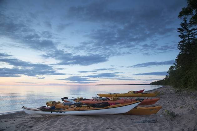 Kayaks on a beach at the edge of Lake Superior, Apostle Islands National Lakeshore, Bayfield peninsula, Wisconsin, USA, July.  1451996 DavidxxPattyn