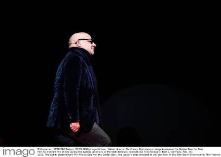 Italian director Gianfranco Rosi steps on stage to receive the Golden Bear for Best Film for the film Fire at Sea during the awards ceremony of the 66th Berlinale International Film Festival in Berlin, Germany, Feb. 20, 2016. The Italian documentary film Fire at Sea won the Golden Bear, the top jury prize awarded to the best film, in the 66th Berlin International Film Festival on Saturday. ) GERMANY-BERLIN-BERLINALE INTERNATIONAL FILM FESTIVAL-AWARDS CEREMONY-GOLD BEAR-GIANFRANCO ROSI ZhangxFan 