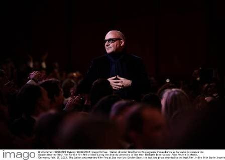 Italian director Gianfranco Rosi agreets the audience as he walks to receive the Golden Bear for Best Film for the film Fire at Sea during the awards ceremony of the 66th Berlinale International Film Festival in Berlin, Germany, Feb. 20, 2016. The Italian documentary film Fire at Sea won the Golden Bear, the top jury prize awarded to the best film, in the 66th Berlin International Film Festival on Saturday. ) GERMANY-BERLIN-BERLINALE INTERNATIONAL FILM FESTIVAL-AWARDS CEREMONY-GOLD BEAR-GIANFRANCO ROSI ZhangxFan 
