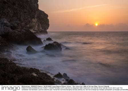 Sun rising over cliffs of Cayman Brac, Cayman Islands.  1466487 WillxBurrard-Lucas