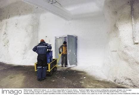 Svalbard Seed Vault workers putting new packages of seed into storage in the -18 deg storage room. Svalbard Global Seed Vault, Svalbard, Norway, October 2012.  1473698 PalxHermansen