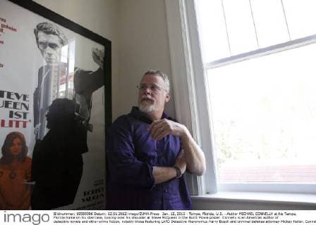 Jan. 12, 2012 - Tampa, Florida, U.S. - Author MICHAEL CONNELLY at his Tampa, Florida home on his staircase, looking over his shoulder at Steve McQueen in the Bulitt Movie poster. Connelly is an American author of detective novels and other crime fiction, notably those featuring LAPD Detective Hieronymus Harry Bosch and criminal defense attorney Mickey Haller. Connelly s books, have been translated into 36 languages and garnered him many awards. - ZUMAl43_