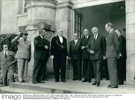 1954 - General de Gaulle leaves guest Chancellor Adenauer at Chateau de Rambouillet after the second day of meetings. Mr. Bratano and Mr. Couve de Murville can be seen standing next to them. - ZUMAk09_