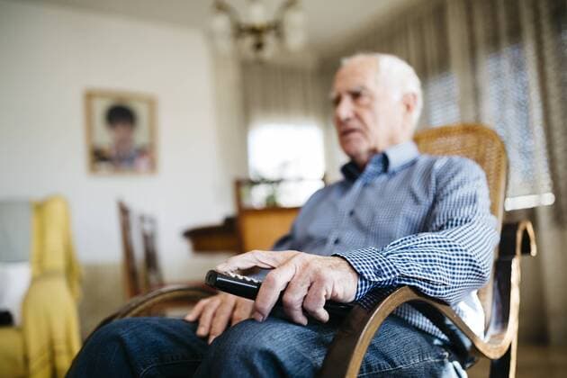 Hand of senior man holding remote control, close-up model released Symbolfoto property released  JRFF000388