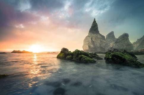 Portugal, Praia Ursa, stone formations at beach against the morning sun  STCF000187