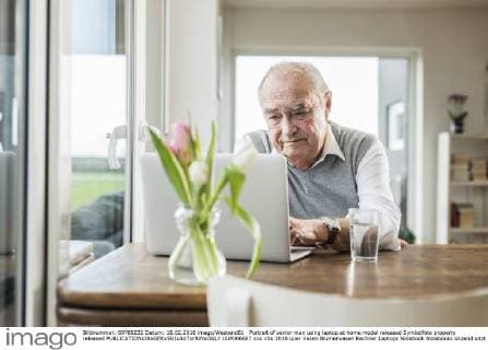 Portrait of senior man using laptop at home model released Symbolfoto property released  UUF006607