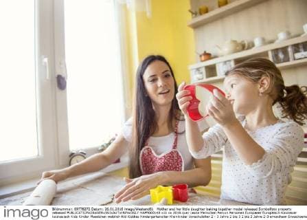Mother and her little daughter baking together model released Symbolfoto property released  HAPF000148