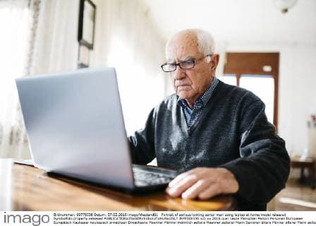 Portrait of serious looking senior man using laptop at home model released Symbolfoto property released  JRFF000356