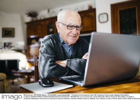 Portrait of smiling senior man with laptop at home model released Symbolfoto property released  JRFF000362