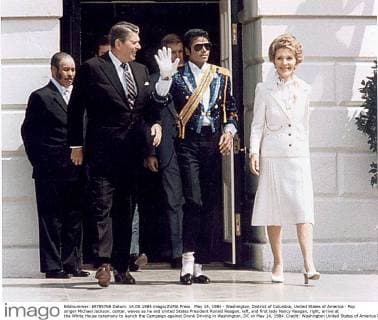 May 14, 1984 - Washington, District of Columbia, United States of America - Pop singer Michael Jackson, center, waves as he and United States President Ronald Reagan, left, and first lady Nancy Reagan, right, arrive at the White House ceremony to launch the Campaign against Drunk Driving in Washington, DC on May 14, 1984..Credit: Washington United States of America - ZUMAs152