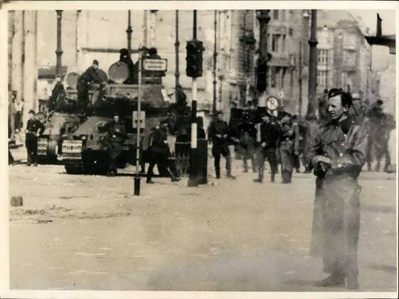 1953 - Demonstrations and riots in East Berlin. Soviet Occupation Troops go into action against civilian population.: Heavy demonstration and street-sights occured in Berlin when laborers residing in East Berlin revolted against the East German Blood-Regime. Trusting that the Soviet High Commissioner, Semjonow, would immediately remove the Ulbricht Grotewohl government, the laborers rose-up and demanded liberty, freedom of speech and de-activation of the People s Police . To the surprise of many demonstrators. The Russiantown commander ordered a tank-brigade into the treatened area, in order to maintain public security and to protect the life of Soviet citizens. Photo shows Soviet tankmen and members of the East German People s Police seen guarding one of the many streets in the East sector. In foreground (Extreme right) One policeman who points his M.P. to the photographer while lo - ZUMAk09_