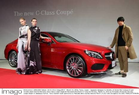 March 14, 2016, Tokyo, Japan - Japanese designer Yu Amatsu of Hanae Mori manuscrit and models stand next to Mercedes-Benz new C-class coupe at Mercedes showroom in Tokyo on Monday, March 14, 2016 as Mercedes introduces the new coupe model on Japanese market. Tokyo fashion week sponsored by Merceds Benz started here on March 14 and runs through to the 19th.  (lwxa000285)