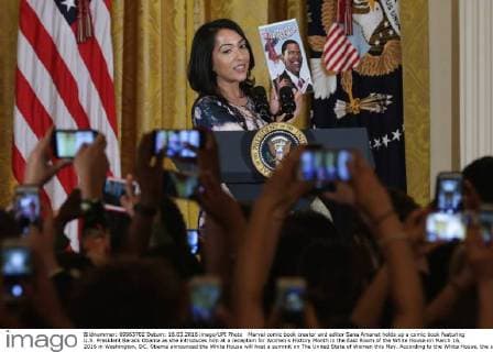 Marvel comic book creator and editor Sana Amanat holds up a comic book featuring U.S. President Barack Obama as she introduces him at a reception for Women s History Month in the East Room of the White House on March 16, 2016 in Washington, DC. Obama announced the White House will host a summit on The United State of Women this May. According to the White House, the summit will highlight the advances we have made in the United States and across the globe and to expand our efforts on helping women confront the challenges they face and reach for their highest aspirations. Pool photo by Chip Somodevilla  WAX20160316208 CHIPxSOMODEVILLA