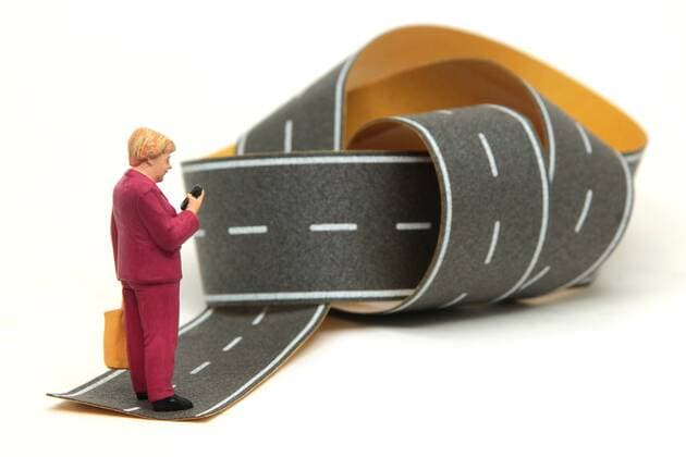 Symbolbild zur politischen Lage in der EU Europäische n Union und der Rolle von Bundeskanzlerin Dr Angela Merkel: Miniatur Figur der Kanzlerin steht allein auf einer verknoteten Straße