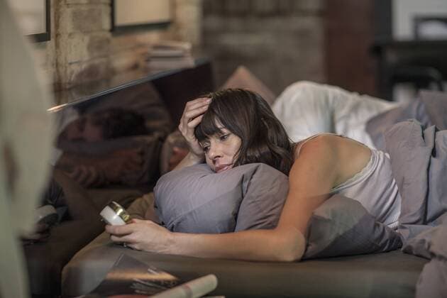 Woman sleepless in bed looking at alarm clock model released Symbolfoto property released  ZEF008407