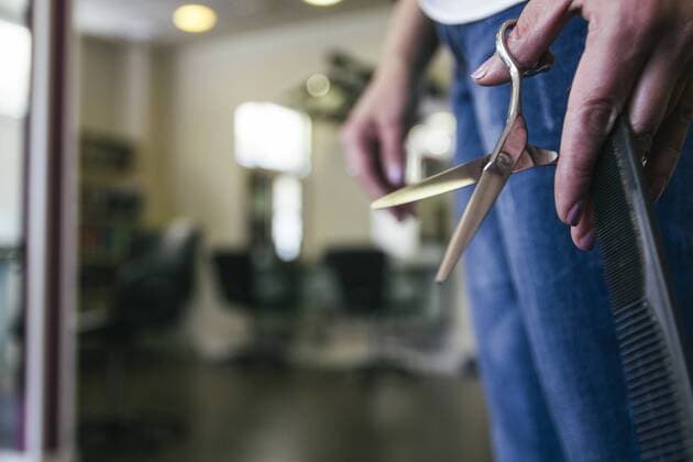 Hairdresser with scissors and comb in her hand model released Symbolfoto property released  ABZF000259