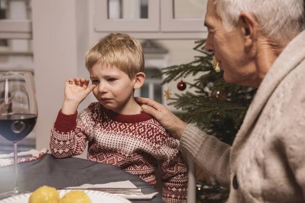 Grandfather comforting sad boy during Christmas dinner model released Symbolfoto property released  MFF002850