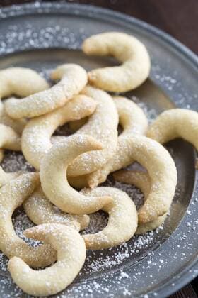 Almond cookies with icing sugar on plate  MYF001358