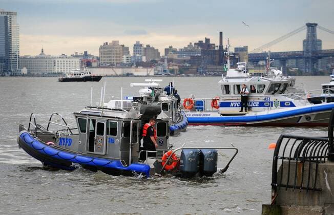 Oct. 4, 2011 - Manhattan, New York, U.S. - Police and firefighters respond as a helicopter carrying five including the pilot crashes in the East River near 34th Street. NYPD divers rescued four, including two women a male and the pilot, the fifth, an unidentified woman was pulled from the water over an hour after the crash. - ZUMAb09_