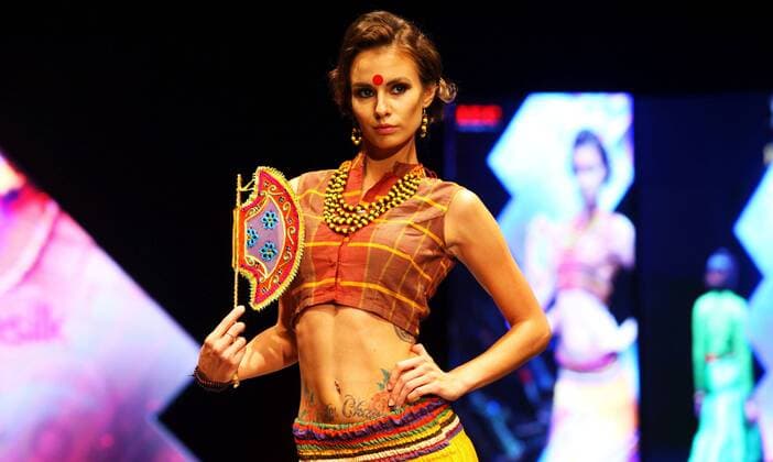 A model wearing designers clothes walks on the stage during the first day of TGIF Nepal Fashion week in Kathmandu, Nepal, March 30, 2016. The four-day fashion week will present both domestic and foreign designers creations. ) NEPAL-KATHMANDU-TGIF NEPAL FASHION WEEK SunilxSharma 
