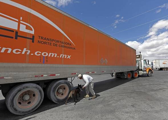 March 31, 2016 - Santa Teresa, NM, U.S. - K-9 security officer Santiago Ramirez and his dog Lord check a truck waiting in line to cross into the United States at the Santa Teresa-San Jeronimo border crossing, near Ciudad Juarez, Mexico, Thursday, March 31, 2016. Santa Teresa U.S. - ZUMAab1_
