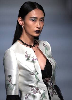Models showcase fashion designs by Zoual Yanti during China s fashion week in Beijing on March 31, 2016. Chinese fashion designers are becoming an international force with both European and American fashion houses looking at the new, fresh Chinese clothing-minds as potential partners in future clothing brands.  PEK2016033147 STEPHENxSHAVER