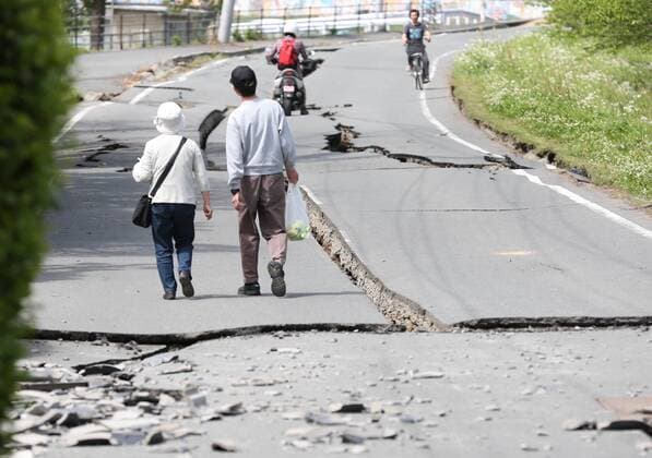 Schweres Erdbeben in Japan (160416) -- KUMAMOTO, April 16, 2016 -- Residents walk on a street cracked by the earthquake in Mashiki, Kumamoto prefecture in southwestern Japan, April 16, 2016. According to local press, at least 15 people were killed after a powerful 7.3-magnitude earthquake rattled Kumamoto Prefecture in Japan s southwestern Kyushu island early Saturday. ) JAPAN-KUMAMOTO-EARTHQUAKE-AFTERMATH liuxtian 