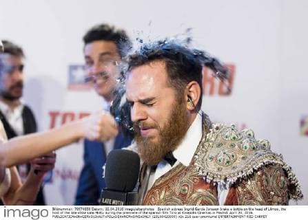 Spanish actress Ingrid Garcia Jonsson brake a bottle on the head of Llimoo, the host of the late show Late Motiv during the premiere of the spanish film Toro at Kinepolis Cinemas in Madrid. April 20, 2016.  (20160420059)