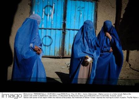 May 13, 2011 - Kabul, Afghanistan - Afghan women on a Kabul street. Before the Taliban took power in Afghanistan, the chardri, or also known as Burqa was rarely and infrequently worn in the cities. However, as the Taliban took power of the region within the interiors of its grasps, the treatment of Taliban women required the wearing of a chadri in public. The full Afghan chadri covers the wearer s entire face except for small region around the eyes, which is covered by a concealing net or grille. Officially, the burqa is not required under the present Afgan Regime, but local warlords still heavenly enforce this rule upon women in that roam the streets of Southern Afghanistan. Due to political instability in areas heavenly controlled by Taliban groups, women become inclined to wear the burqa as protection for their personal safety. - ZUMAh85_