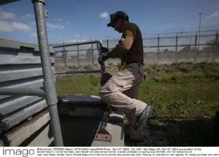April 27, 2016 - CA, USA - San Diego, CA. April 27, 2016 Lance LeNoir of the Border Patrol s Tunnel Rat team, lets himself into the vertical tunnel, a series of ladders dropping down 90 feet, into the Galvez tunnel near Otay Mesa. Border Patrol officials keep one of the many tunnels discovered near Otay Mesa as an example for new agents, for media purposes and training operations. Known as the Galvez tunnel, it s an example of one of the more developed tunnels, having nearly twice the height of the recently discovered tunnels, with electrical wiring and rails for moving bundles under the border. Mandatory photo credit: USA - ZUMAs44_
