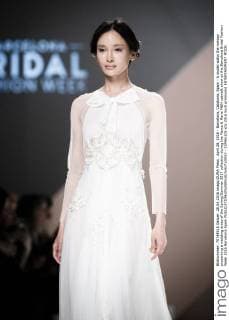April 28, 2016 - Barcelona, Catalonia, Spain - A model walks the runway presenting a wedding dress of the Spring Summer 2017 collection during the Marco & Maria M&M catwalk show at the Barcelona Bridal Fashion Week 2016 Barcelona Spain - ZUMAo105