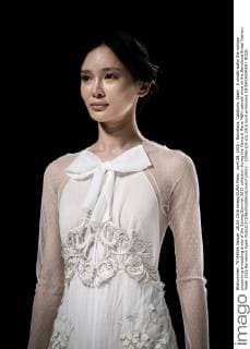 April 28, 2016 - Barcelona, Catalonia, Spain - A model walks the runway presenting a wedding dress of the Spring Summer 2017 collection during the Marco & Maria M&M catwalk show at the Barcelona Bridal Fashion Week 2016 Barcelona Spain - ZUMAo105