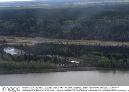 Aerial view of highway 63, south of Fort McMurray, taken from a CH-146 Griffon helicopter on May 5, 2016. The Canadian Armed Forces have air assets deployed in support of the Province of Alberta s wildfire emergency response efforts. At the time this image was taken, a mandatory evacuation had been placed on all of Fort McMurray - the largest evacuation on record in Canada. The fire had burned through nearly 77 square kilometers, razing neighborhoods across the city.  WAX2016050629 MCplxVanPutten