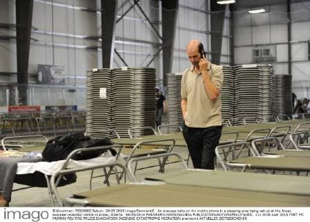 An evacuee talks on his mobile phone in a sleeping area being set up at the Anzac evacuee reception centre in Anzac, Alberta. 04 05 2016 PANORAMIC GREGHALINDA 