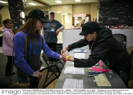 (160509) -- FORT MCMURRAY, May 9, 2016 -- Evacuees are seen in Bold community center in Lac la Biche south of Fort McMurray, Alberta, Canada on May 9, 2016. The spread of the huge wildfire in western Canada that has forced a massive evacuation in the oil sands town of Fort McMurray in northern Alberta province appeared to be slowing down on Sunday, partly thanks to favorable weather. ) CANADA-FORT MCMURRAY-WILDFIRE-AFTERMATH AmruxSalahuddien 