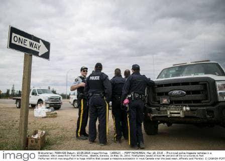 (160510) -- FORT MCMURRAY, May 10, 2016 -- Provincial police inspects vehicles in a roadblock 10km away from Fort McMurray, Alberta, Canada, on May 10, 2016. Firefighters saved almost 90 percent of the structures in Fort McMurray which was engulfed in a huge wildfire that caused a massive evacuation in west Canada over the past week, officials said Monday. () CANADA-FORT MCMURRAY-WILDFIRE-AFTERMATH AmruxSalahuddien 