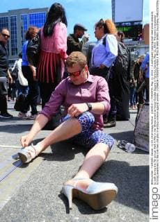 (160512) -- TORONTO, May 12, 2016 -- A participant wearing high-heel shoes prepares to walk during the 7th annual Walk A Mile In Her Shoes event at Yonge-Dundas Square in Toronto, Canada, May 12, 2016. The event is expected to bring awareness to the role men can play in ending violence against women. ) CANADA-TORONTO-WALK A MILE IN HER SHOES ZouxZheng 
