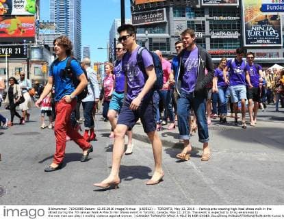 (160512) -- TORONTO, May 12, 2016 -- Participants wearing high-heel shoes walk in the street during the 7th annual Walk A Mile In Her Shoes event in Toronto, Canada, May 12, 2016. The event is expected to bring awareness to the role men can play in ending violence against women. ) CANADA-TORONTO-WALK A MILE IN HER SHOES ZouxZheng 