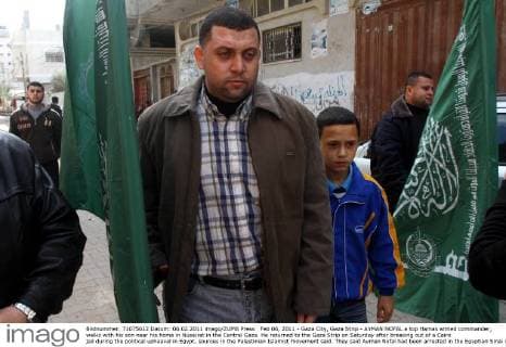 Feb 06, 2011 - Gaza City, Gaza Strip - AYMAN NOFAL a top Hamas armed commander, walks with his son near his home in Nusairat in the Central Gaza. He returned to the Gaza Strip on Saturday after breaking out of a Cairo jail during the political upheaval in Egypt, sources in the Palestinian Islamist movement said. They said Ayman Nofal had been arrested in the Egyptian Sinai in early 2008. - ZUMAap3_