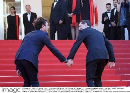 69. Festival de Cannes: Elle Filmpremiere Kev Adams (L) and Gad Elmaleh hold hands as the climb the steps of the Palais des Festivals before the screening of the film Elle at the 69th annual Cannes International Film Festival in Cannes, France on May 21, 2016.  CAN20160521818 DAVIDxSILPA
