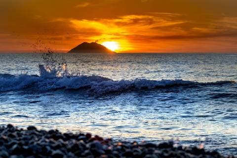 Italy, Sicily, Aeolian Islands, View to Isola Stromboli at sunset  CSTF001055