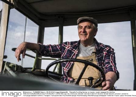 Portrait of smiling farmer on tractor model released Symbolfoto  UUF007363
