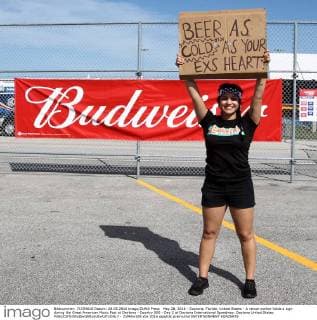May 28, 2016 - Daytona, Florida, United States - A venue worker holds a sign during the Great American Music Fest at Daytona - Country 500 - Day 2 at Daytona International Speedway. Daytona United States - ZUMAw109