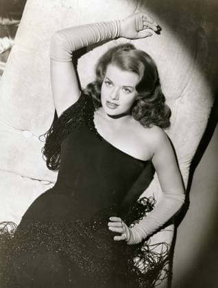 The American actress Janis Paige wears a black dress and long gloves x03584x 