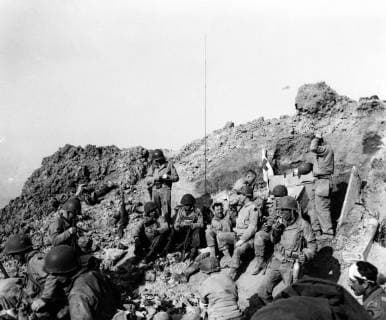 U.S. Army Rangers rest atop the cliffs at Pointe du Hoc, which they stormed in support of the Omaha Beach landings on D-Day, June 6, 1944. Photograph was released for publication on June 12, 1944.  WAX2016060121 U.S.xNavy