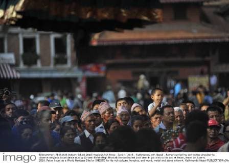June 4, 2016 - Kathmandu, NP, Nepal - Father carried his son on the shoulder to observe religious ritual dance during 12 year Shree Bagh Bhairab Dance festival (not seen in picture) to his son at Patan, Nepal on June 4, 2016. Patan listed as a World Heritage Site by UNESCO for its rich culture, temples, and wood, metal and stone artwork. Kathmandu Nepal  - ZUMAn230
