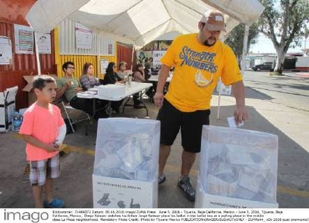 June 5, 2016 - Tijuana, Baja California, Mexico - June 5, 2016, Tijuana, Baja California, Mexico_ Diego Salazar watches his father Jorge Salazar place his ballot in the ballot box at a polling place in the middle class La Mesa neighborhood. Mandatory Photo Credit: Photo by Tijuana Mexico - ZUMAs44_