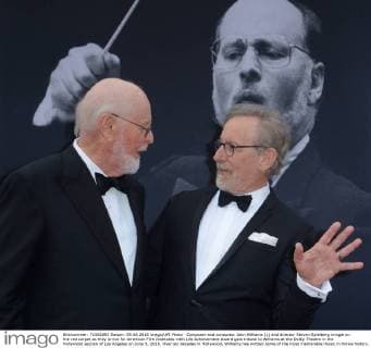 Composer and conductor John Williams (L) and director Steven Spielberg mingle on the red carpet as they arrive for American Film Institutes 44th Life Achievement Award gala tribute to Williams at the Dolby Theatre in the Hollywood section of Los Angeles on June 9, 2016. Over six decades in Hollywood, Williams has written some of the most memorable music in movie history. His 100-plus features have earned 50 Academy Award nominations (making him the most-nominated living person), winning five times. Williams also received 22 Grammys, seven BAFTAs, five Emmys, four Golden Globes, a Kennedy Center Honor and the National Medal of Arts. And then there are all those iconic themes, the ones everyone in the world knows.  LAP2016060904 JIMxRUYMEN