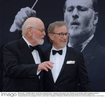 Composer and conductor John Williams (L) and director Steven Spielberg mingle on the red carpet as they arrive for American Film Institutes 44th Life Achievement Award gala tribute to Williams at the Dolby Theatre in the Hollywood section of Los Angeles on June 9, 2016. Over six decades in Hollywood, Williams has written some of the most memorable music in movie history. His 100-plus features have earned 50 Academy Award nominations (making him the most-nominated living person), winning five times. Williams also received 22 Grammys, seven BAFTAs, five Emmys, four Golden Globes, a Kennedy Center Honor and the National Medal of Arts. And then there are all those iconic themes, the ones everyone in the world knows.  LAP2016060911 JIMxRUYMEN