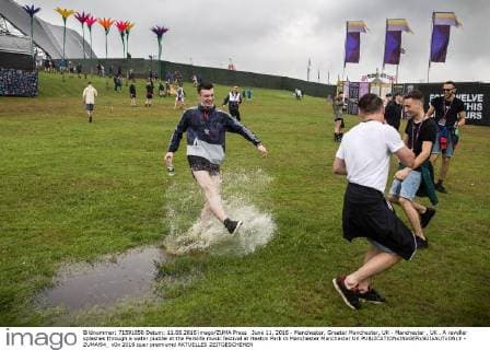 June 11, 2016 - Manchester, Greater Manchester, UK - Manchester , UK . A reveller splashes through a water puddle at the Parklife music festival at Heaton Park in Manchester Manchester UK  - ZUMAl94_